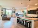 Open concept living area featuring a kitchen island, living room, and a ceiling fan at 1280 W Blue Ridge Dr, San Tan Valley, AZ 85140