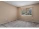 Neutral bedroom with a window providing views, carpet floors, and neutral walls at 13284 W Aleppo Dr, Sun City West, AZ 85375