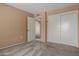 Bedroom with carpet floors, standard closet, and access to an adjacent room at 13284 W Aleppo Dr, Sun City West, AZ 85375