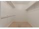 Walk-in closet featuring neutral carpet, white walls, and hanging storage at 13284 W Aleppo Dr, Sun City West, AZ 85375