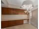 Traditional dining area with wood cabinets and countertop, and a decorative chandelier at 13284 W Aleppo Dr, Sun City West, AZ 85375