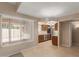 Bright kitchen/dining area featuring tile floors, dark wood cabinets, stainless appliances, and backyard views at 13284 W Aleppo Dr, Sun City West, AZ 85375