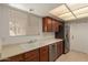 Clean kitchen with updated stainless steel appliances, white countertops, and plenty of cabinet storage space for organization at 13284 W Aleppo Dr, Sun City West, AZ 85375