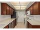 Efficient kitchen featuring wood cabinetry, stainless steel appliances, and tile flooring at 13284 W Aleppo Dr, Sun City West, AZ 85375