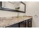 Bathroom vanity featuring granite countertops, modern fixtures, and a glass vessel sink at 1633 E Lakeside Dr # 106, Gilbert, AZ 85234