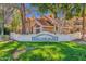 Beautiful Beach Club Village facade, showcasing lush green lawn, mature trees, and attractive architecture at 1633 E Lakeside Dr # 106, Gilbert, AZ 85234