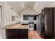 Modern kitchen featuring stainless steel appliances, granite countertops, and dark cabinetry, enhancing the home's appeal at 1633 E Lakeside Dr # 106, Gilbert, AZ 85234