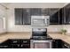 Well-equipped kitchen with stainless steel appliances, granite counters, and dark cabinets at 1633 E Lakeside Dr # 106, Gilbert, AZ 85234