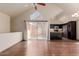 Spacious living area featuring vaulted ceilings, wood flooring, and sliding glass doors leading to outdoor space at 1633 E Lakeside Dr # 106, Gilbert, AZ 85234