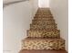 Stairway featuring decorative mosaic tile, wooden risers, and neutral wall paint at 1633 E Lakeside Dr # 106, Gilbert, AZ 85234