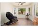 Cozy sitting area within bedroom offering natural light and a view of the lush exterior at 16564 W Wild Horse Way, Surprise, AZ 85387