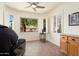 Relaxing bonus room with a large window, tile floors, and plantation shutters at 16564 W Wild Horse Way, Surprise, AZ 85387