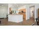 Bright kitchen with light wood cabinets, granite countertops, and a center island at 16564 W Wild Horse Way, Surprise, AZ 85387