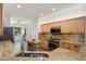 Well-lit kitchen featuring light wood cabinets, granite countertops, and stainless-steel appliances at 16564 W Wild Horse Way, Surprise, AZ 85387