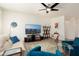 Comfortable living room featuring a neutral sofa, bright-blue chairs and a ceiling fan at 16564 W Wild Horse Way, Surprise, AZ 85387