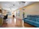 A living room with hardwood floors, a blue sofa, built-in cabinets and view to the patio at 16564 W Wild Horse Way, Surprise, AZ 85387