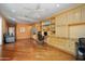 Spacious living room featuring hardwood floors, built-in shelves, and a dedicated workspace at 16564 W Wild Horse Way, Surprise, AZ 85387