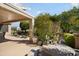 Outdoor patio area with lush landscaping offering a serene backyard retreat at 16564 W Wild Horse Way, Surprise, AZ 85387