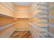 Organized walk-in closet featuring extensive wire shelving and hardwood floors at 16564 W Wild Horse Way, Surprise, AZ 85387