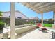 Relaxing backyard lounging area with built-in seating, lounge chair and view of lawn at 17637 W Browning Dr, Surprise, AZ 85374