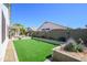 Spacious backyard with artificial turf, planter boxes, and privacy fence, perfect for outdoor activities at 17637 W Browning Dr, Surprise, AZ 85374