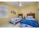Bright bedroom showcasing two beds, soft natural light and neutral colored walls at 17637 W Browning Dr, Surprise, AZ 85374