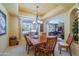 Elegant dining room featuring a coffered ceiling, chandelier, and views of a window at 17637 W Browning Dr, Surprise, AZ 85374
