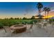 Exterior patio area with outdoor fireplace and beautiful view of the lush green golf course at 17637 W Browning Dr, Surprise, AZ 85374