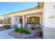 Inviting front porch with seating area, decorative plants, and charming curb appeal at 17637 W Browning Dr, Surprise, AZ 85374
