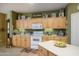 Bright eat-in kitchen with honey-colored cabinets, modern appliances, and charming décor at 17637 W Browning Dr, Surprise, AZ 85374