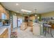 Sunlit kitchen featuring wood cabinets, a skylight, an island, and modern appliances at 17637 W Browning Dr, Surprise, AZ 85374