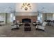 Comfortable lounge area with a brick fireplace, plush seating, and a decorative wall art at 17637 W Browning Dr, Surprise, AZ 85374