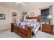 Cozy primary bedroom featuring a wooden bed frame, soft lighting, and a relaxing atmosphere at 17637 W Browning Dr, Surprise, AZ 85374