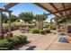 Outdoor seating area with tables and BBQ grills overlooking the lush green golf course at 17637 W Browning Dr, Surprise, AZ 85374