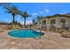 Community pool area with wrought iron fencing and plentiful lounge chairs and seating at 17637 W Browning Dr, Surprise, AZ 85374
