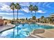 Beautiful pool area featuring waterfall feature and gorgeous mature palm trees at 17637 W Browning Dr, Surprise, AZ 85374
