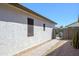 Functional side yard with a paved walkway, gravel landscaping, and secure gate access at 17637 W Browning Dr, Surprise, AZ 85374