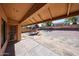 Covered patio overlooking a large backyard featuring a wood play structure and block wall fencing at 1833 E Redfield Rd, Phoenix, AZ 85022