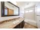Well-lit bathroom features vanity with granite countertops, and a shower and bathtub combination at 1833 E Redfield Rd, Phoenix, AZ 85022