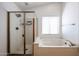 Relax in this bathtub or enjoy the walk in shower featured in this bathroom at 1833 E Redfield Rd, Phoenix, AZ 85022