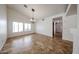 Airy dining room features a chandelier, vaulted ceilings, tile floors, and lots of natural light at 1833 E Redfield Rd, Phoenix, AZ 85022