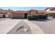 Charming single-story home with a red tile roof, a two car garage and desert landscaping at 1833 E Redfield Rd, Phoenix, AZ 85022