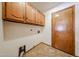 The laundry room features wood cabinets and tile floors at 1833 E Redfield Rd, Phoenix, AZ 85022