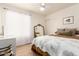 Bright bedroom featuring natural light, a large mirror, wood-look tile flooring, and neutral decor throughout at 1838 E Crocus Dr, Phoenix, AZ 85022