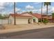 Well-maintained single-story home with a tile roof, two-car garage, and low-maintenance landscaping at 1838 E Crocus Dr, Phoenix, AZ 85022