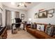 This home office features a wood-look tile floor, work space, and a comfortable sofa for relaxing and reading at 1838 E Crocus Dr, Phoenix, AZ 85022