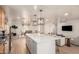 Open concept kitchen with a large island, pendant lights, and a view of the dining and living areas at 1838 E Crocus Dr, Phoenix, AZ 85022