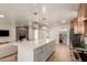 Open floorplan with kitchen island and seating, living room, and dining room at 1838 E Crocus Dr, Phoenix, AZ 85022