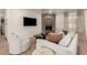 Cozy living room features a decorative fireplace, comfortable seating, a ceiling fan, and neutral decor at 1838 E Crocus Dr, Phoenix, AZ 85022