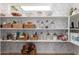 Organized walk-in pantry featuring multiple shelves and a floral patterned wallpaper at 1838 E Crocus Dr, Phoenix, AZ 85022